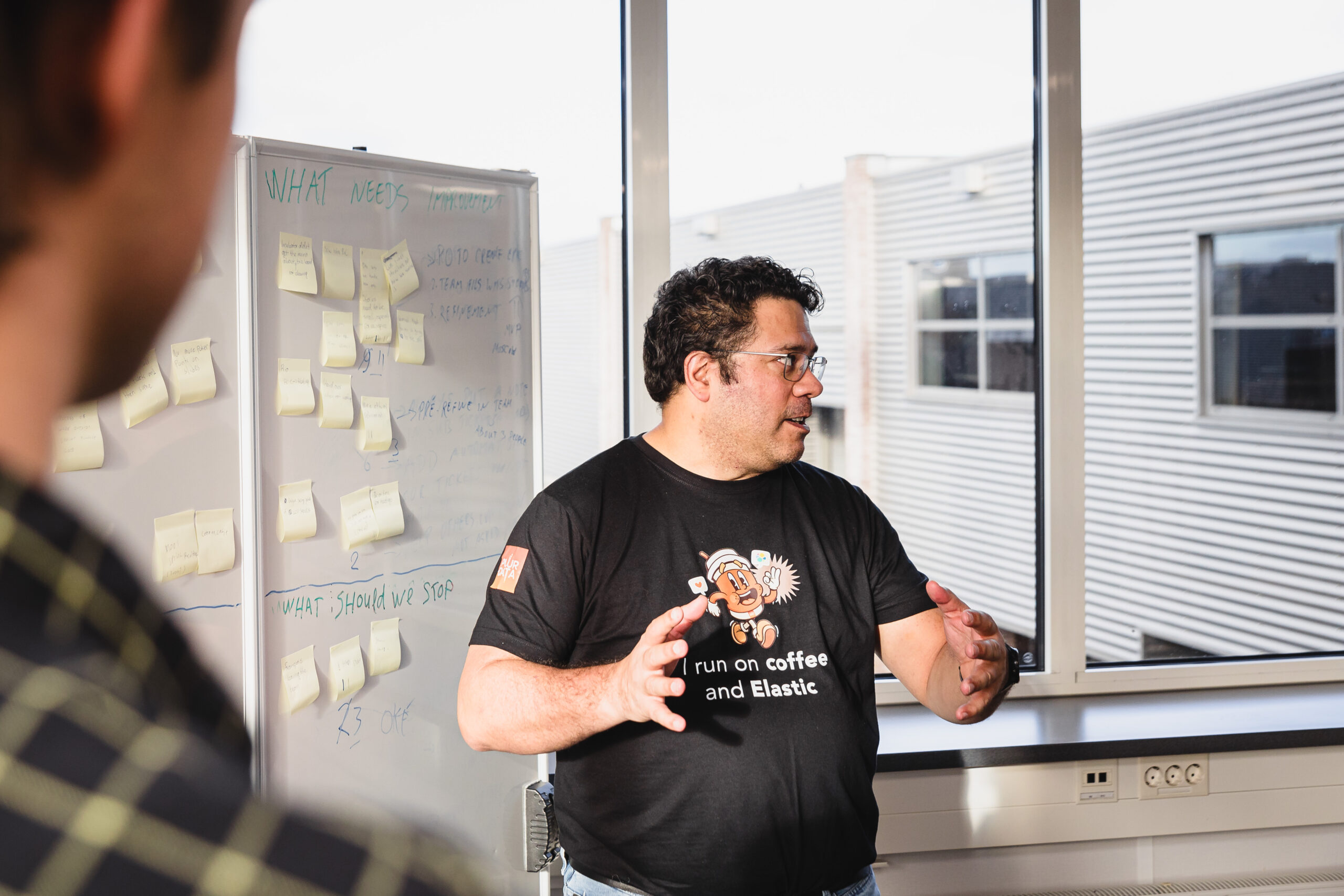 Person standing in front of a whiteboard.