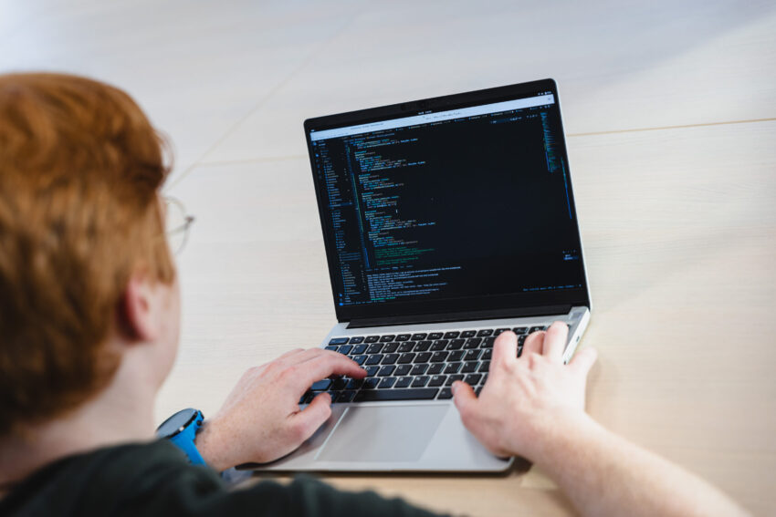 A person typing on his laptop.