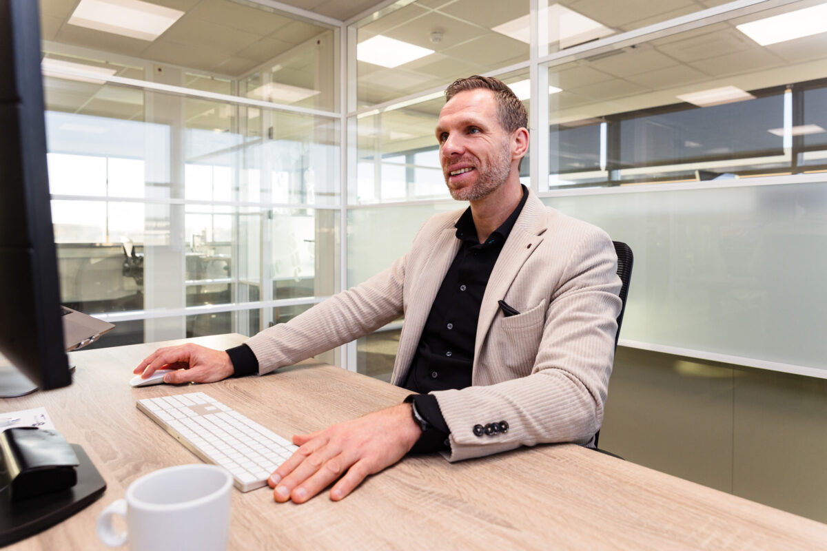 Person sitting at a desk behind a computer.