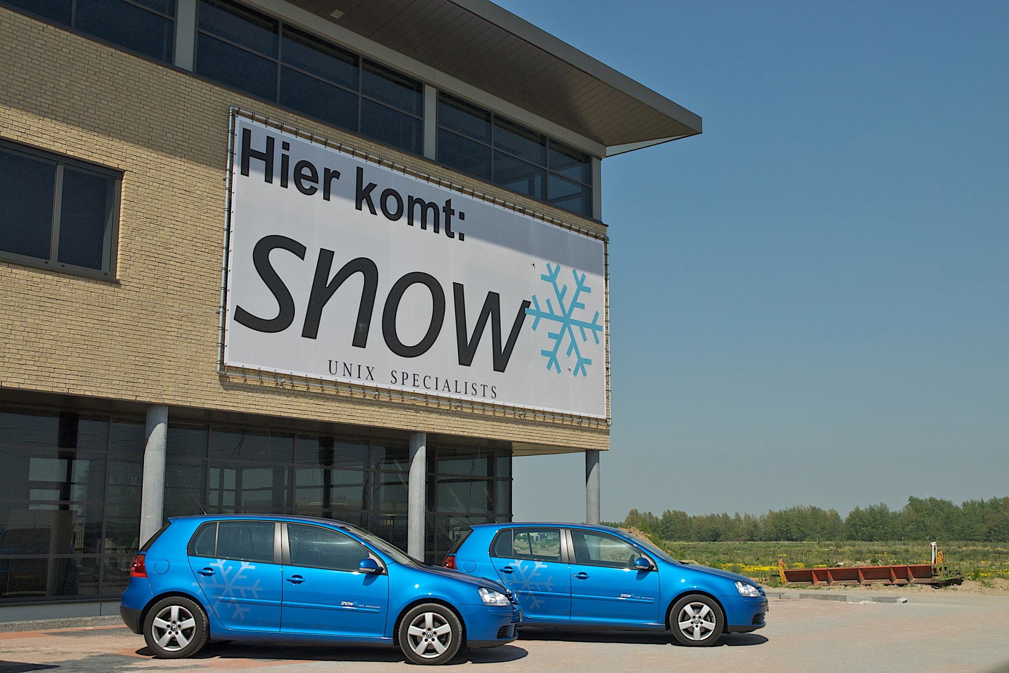 Cars with SUE logo in front of SUE office previously known as Snow